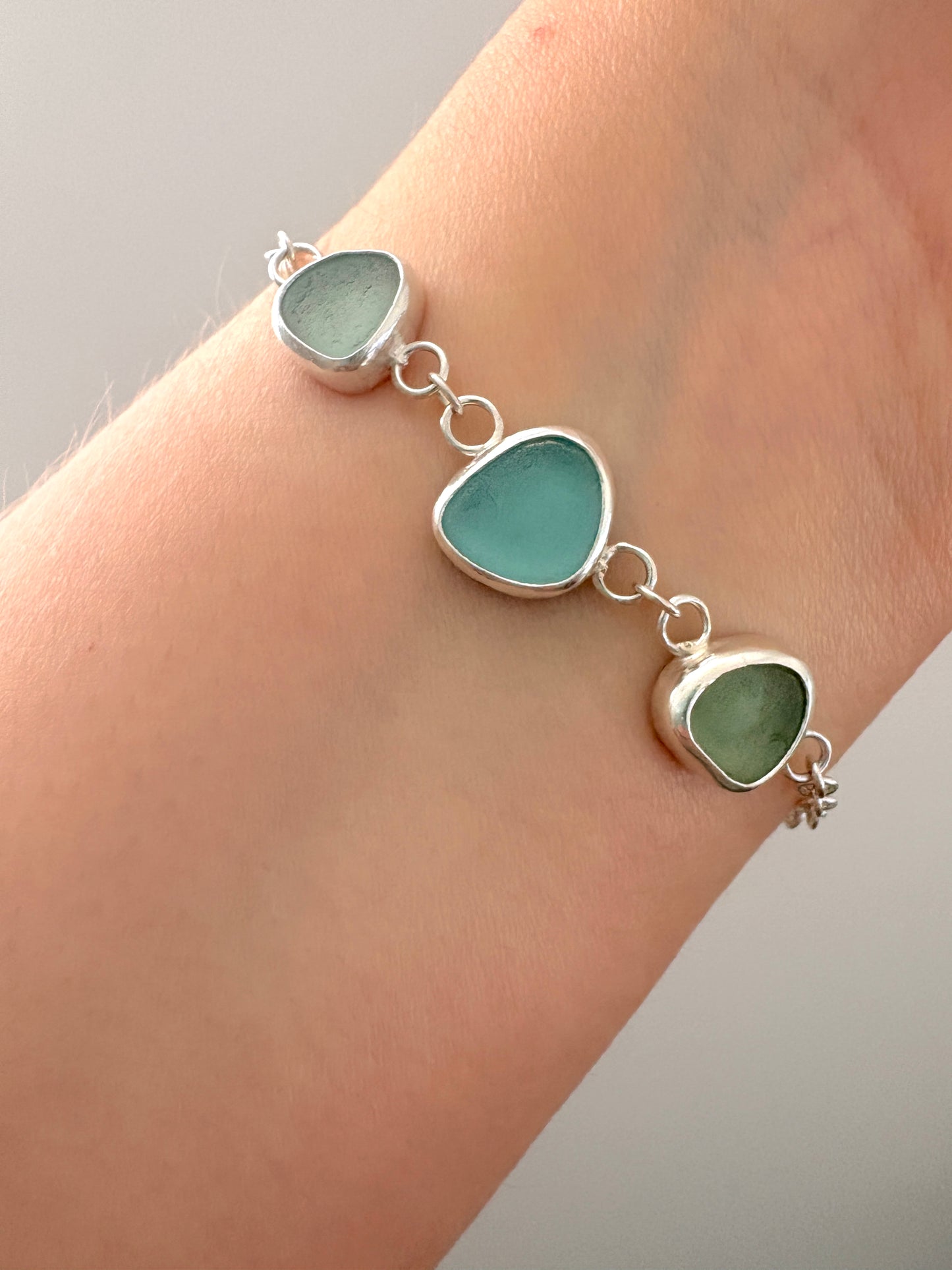 sterling silver bracelet with three pieces of seaglass 