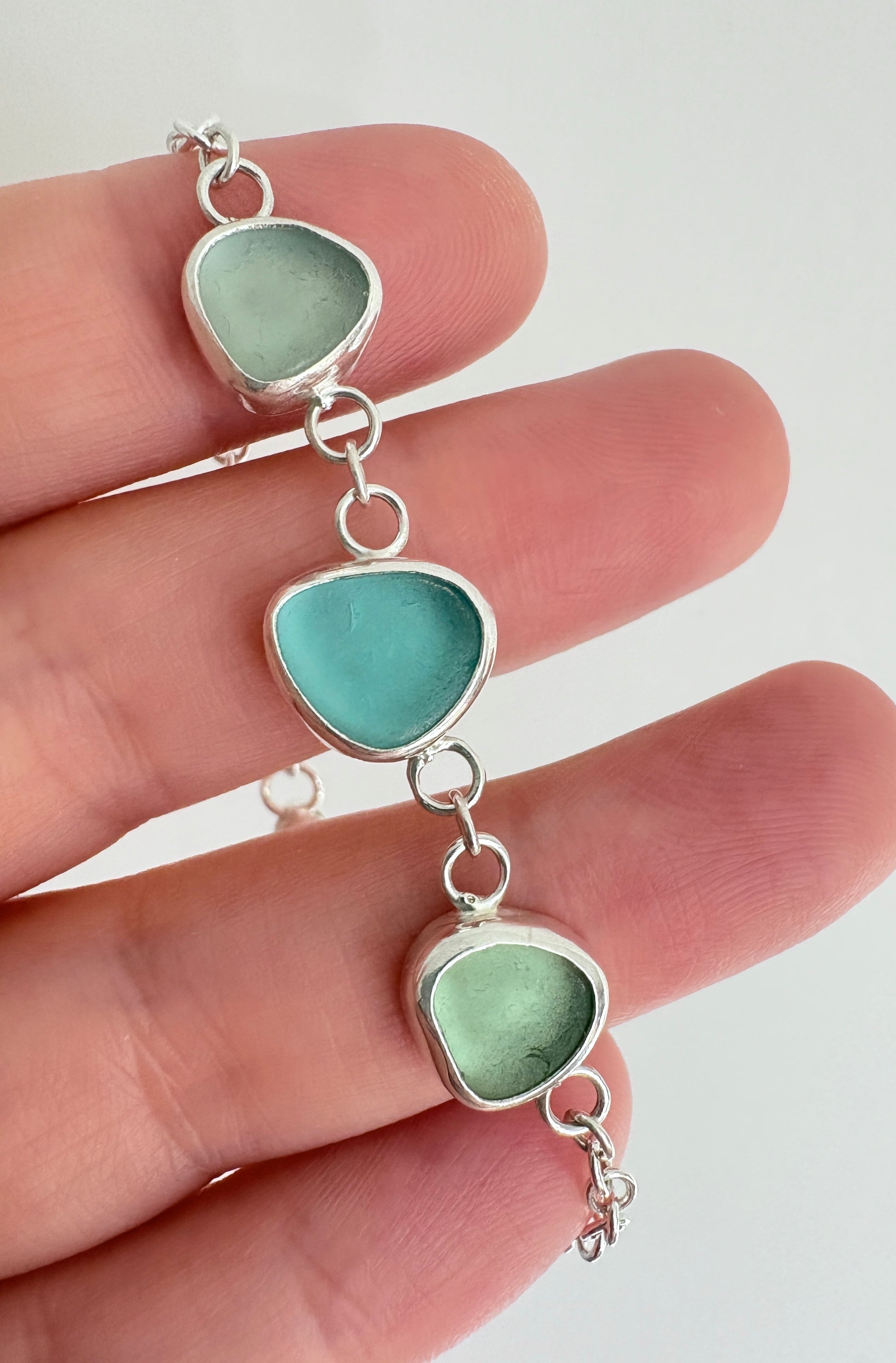 sterling silver bracelet with three pieces of seaglass